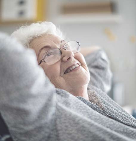 Older woman smiling and looking at the ceiling